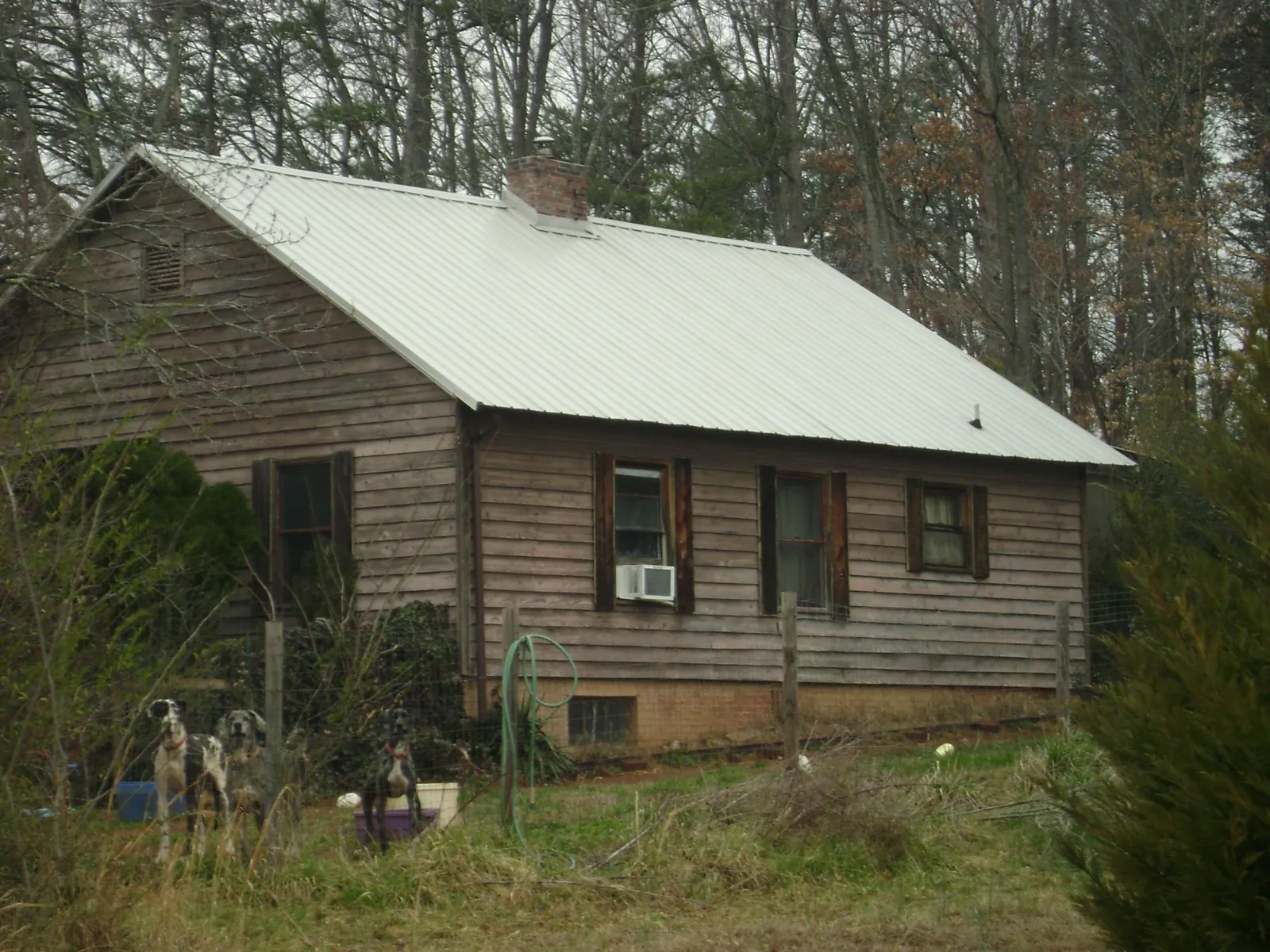 White metal roof on an old wood sided farmhouse, from a Asphalt Shingle Roof Repair job in Duquesne